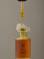 Image of product renew serum with a flower perched inside. The dropper is being dropped on the flower